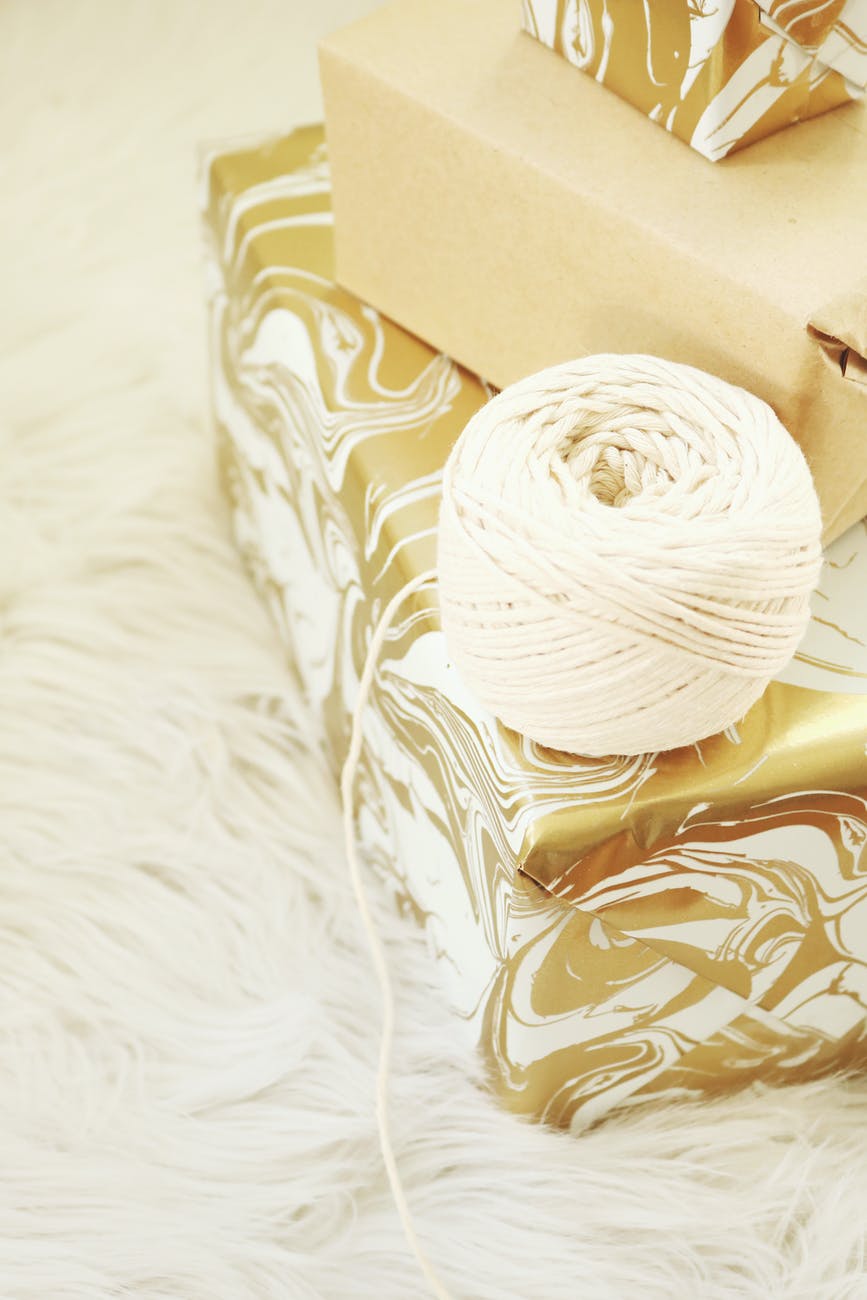 white yarn thread near brown box