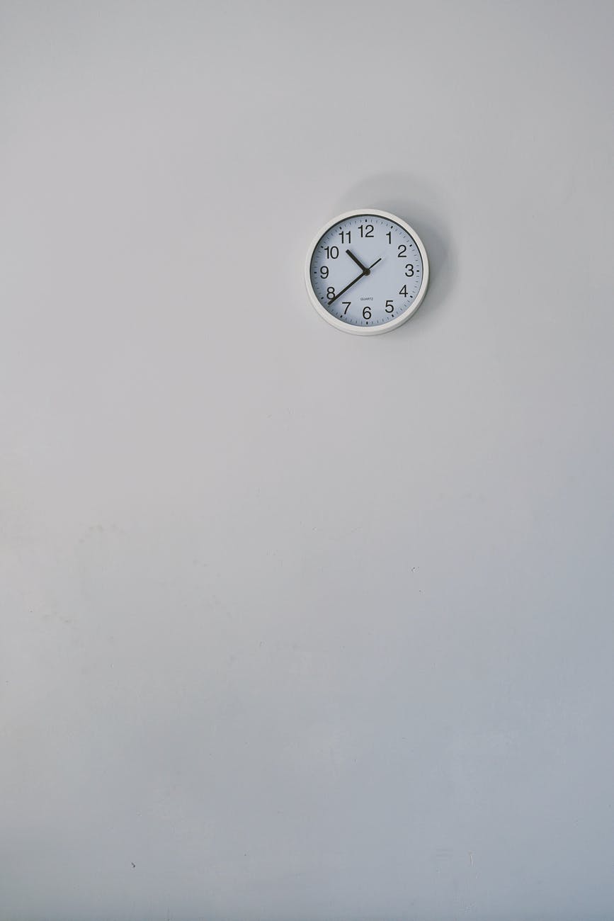 silver round wall clock mounted on wall