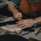 shoemaker cutting leather