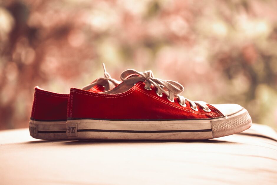 pair of red low top sneakers in bokeh photography