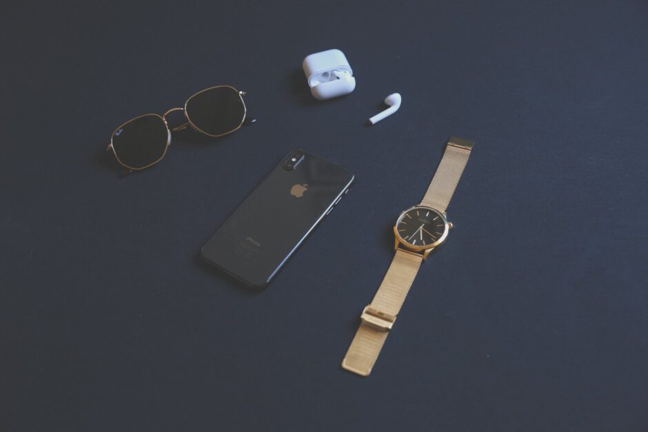 photo of iphone near sunglasses and watch