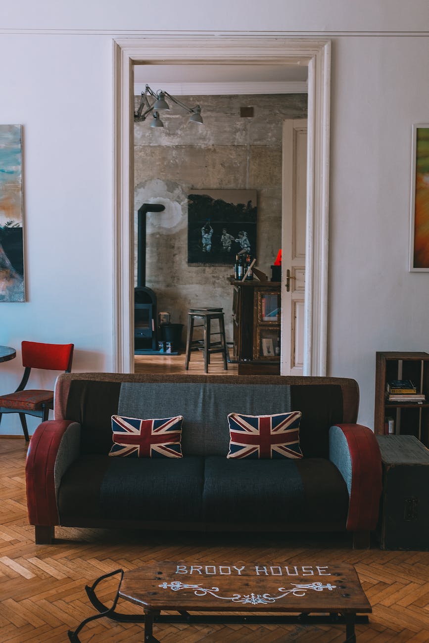 cozy living room with sofa with uk flag cushions and vintage wooden furniture