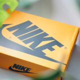 close up photo of a yellow nike shoebox