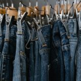 close up photo of denim jeans on a clothing rack
