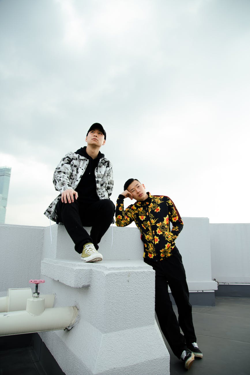 stylish ethnic men on rooftop in cloudy day