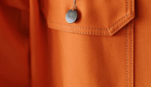 an orange button on a pocket