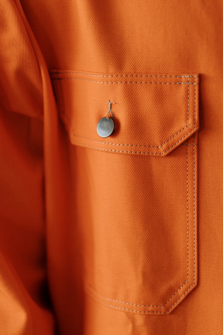 an orange button on a pocket