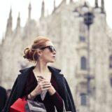 shallow focus photography of woman holding assorted color paper bags