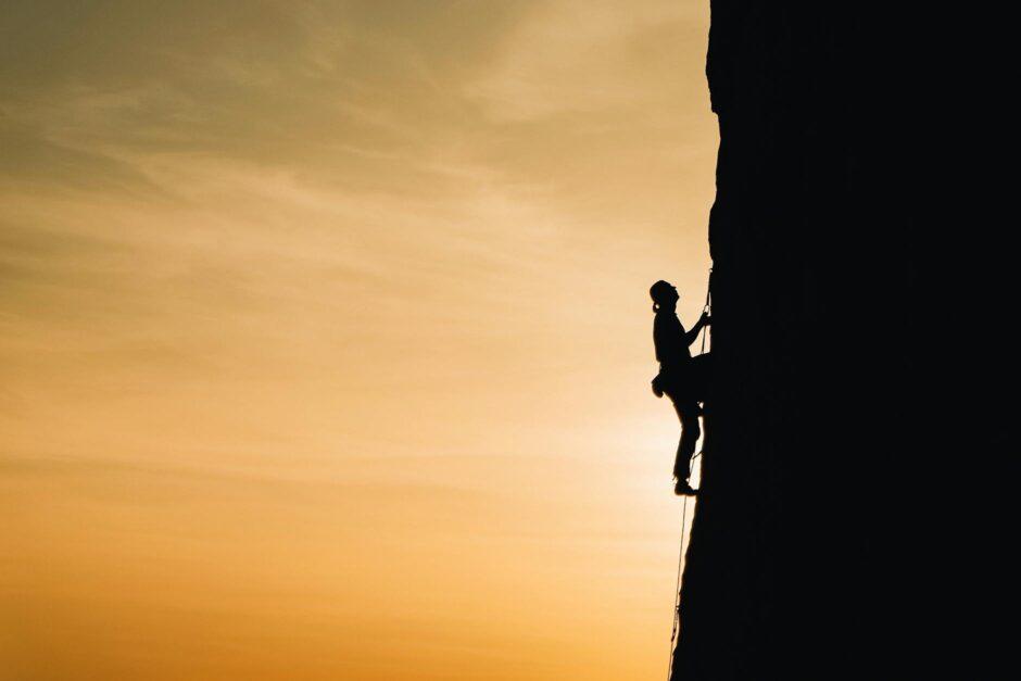 person rock climbing