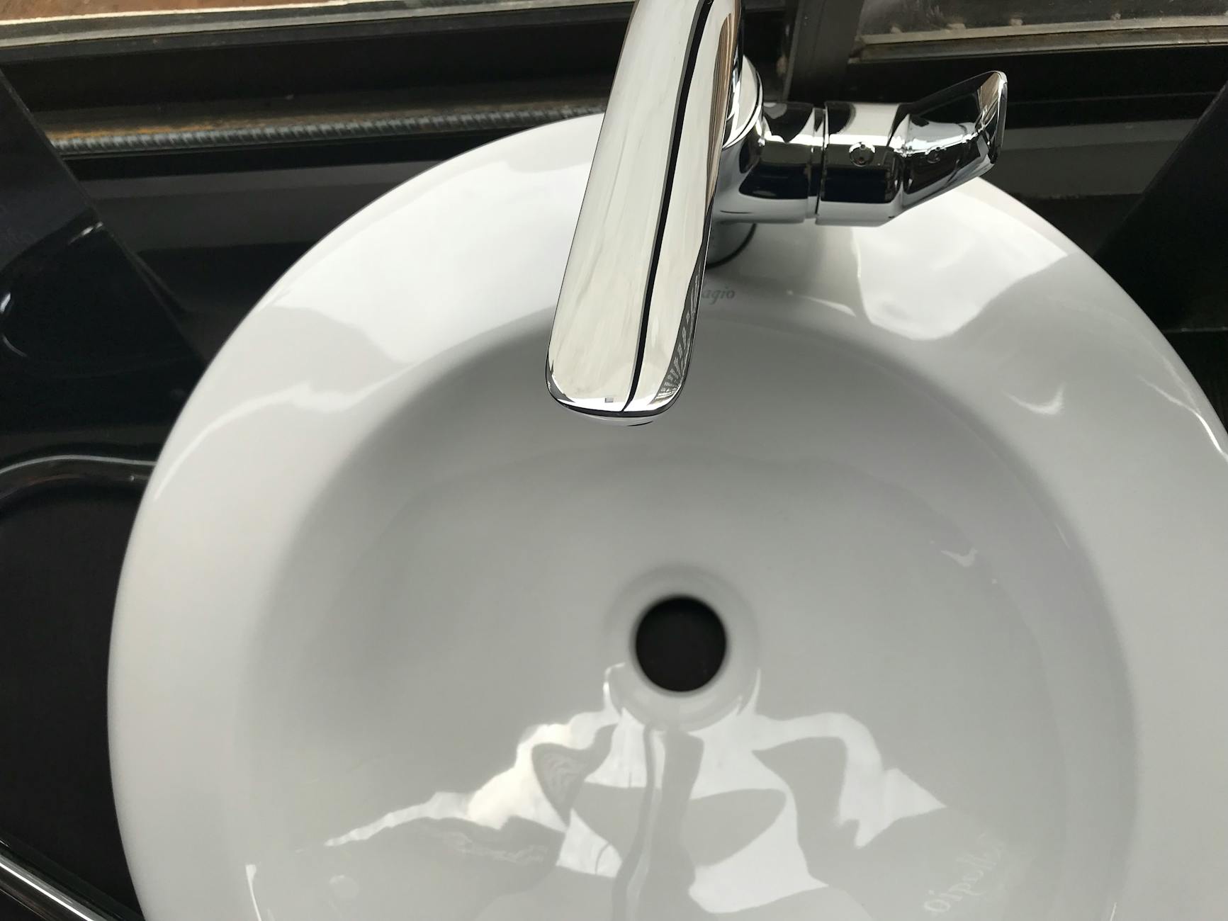 white ceramic sink with stainless steel faucet
