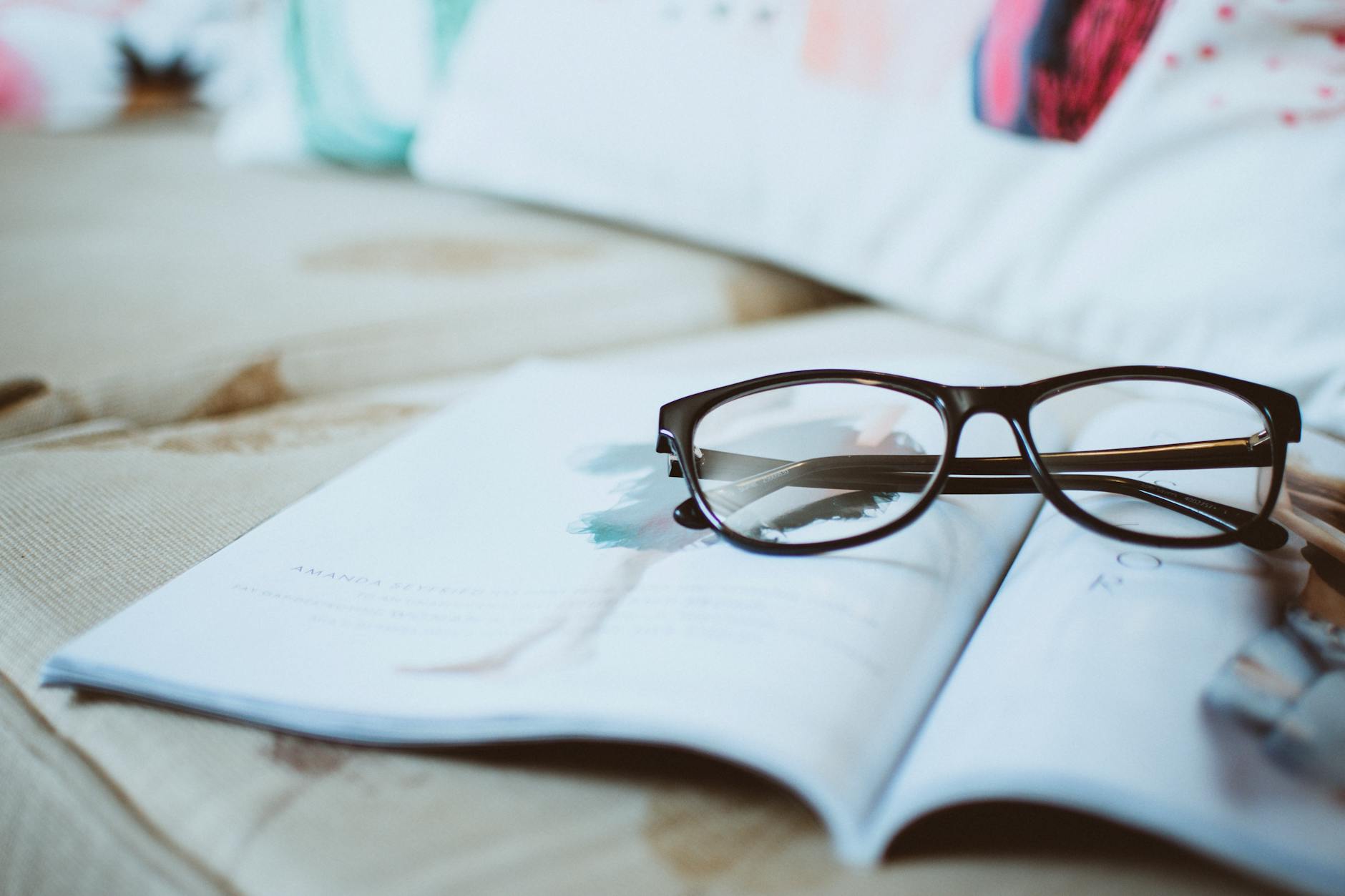 black framed eyeglasses on paper