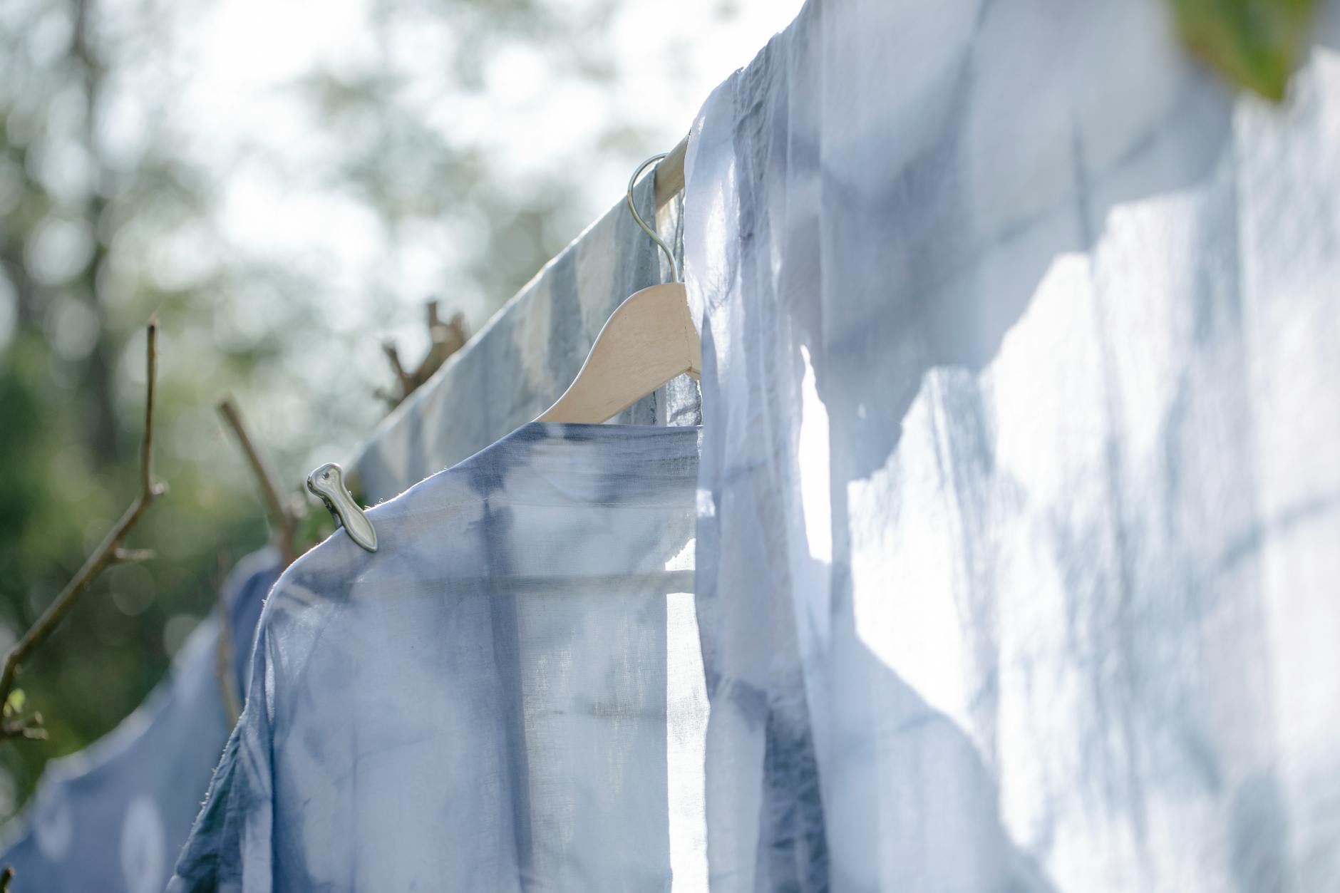 washed linen hanging on rope in garden