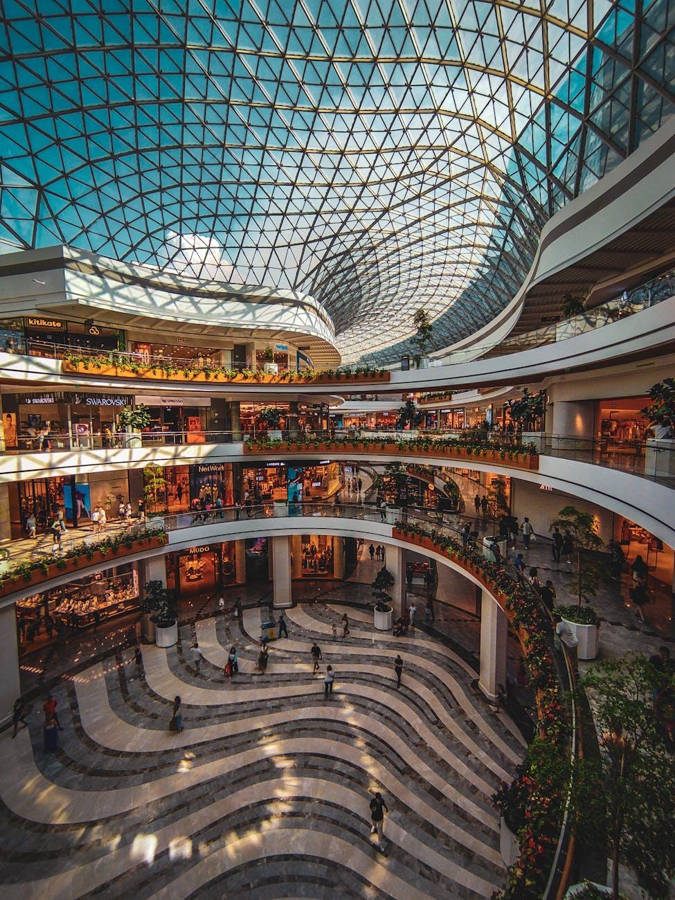 the inside of a shopping mall with a glass roof
