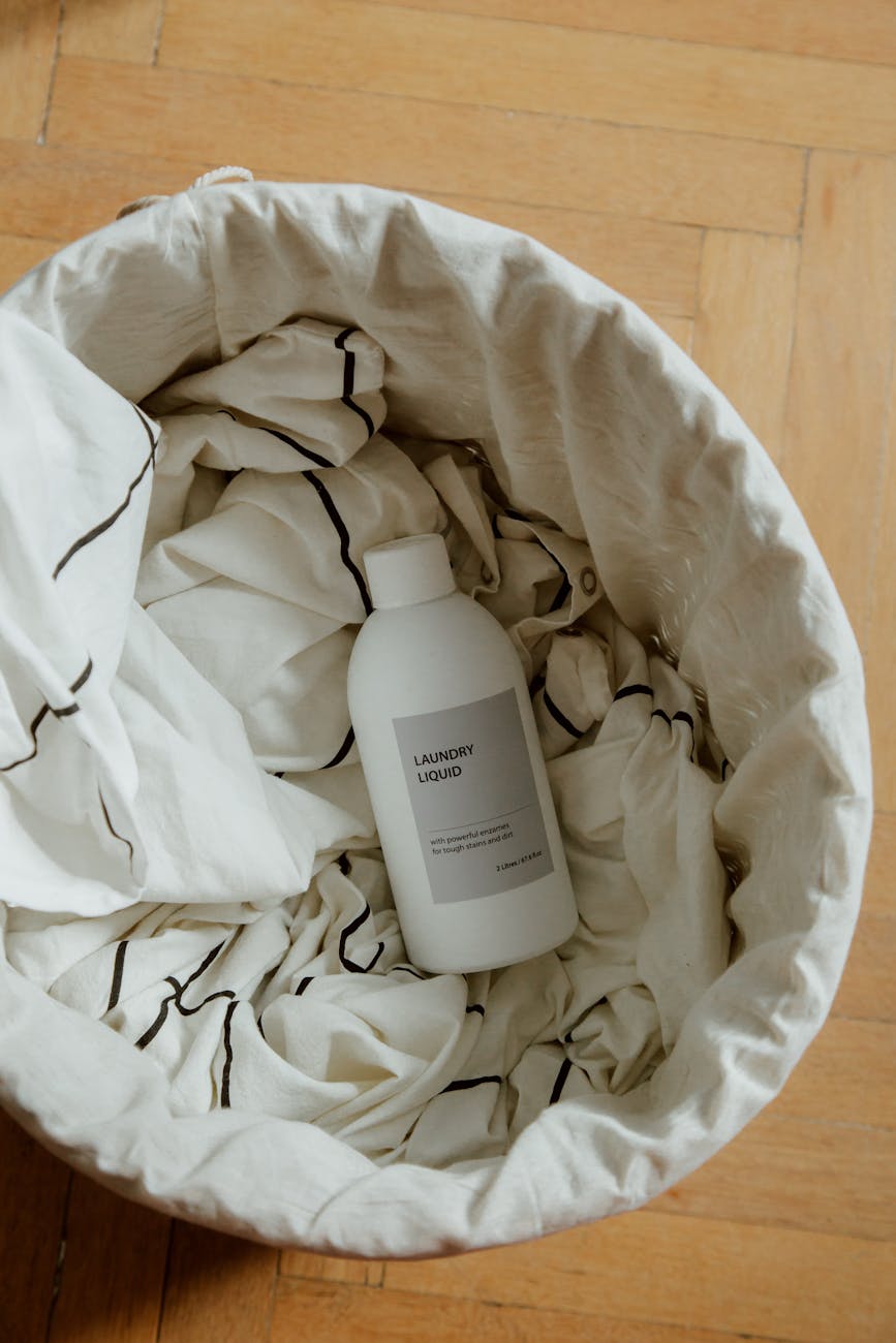 bottle of cleaning product in laundry basket